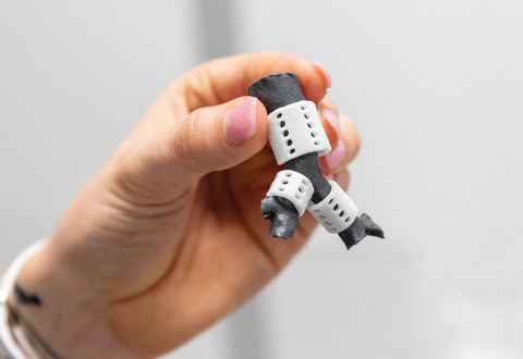 Picture of a man's hand holding a 3d printed object